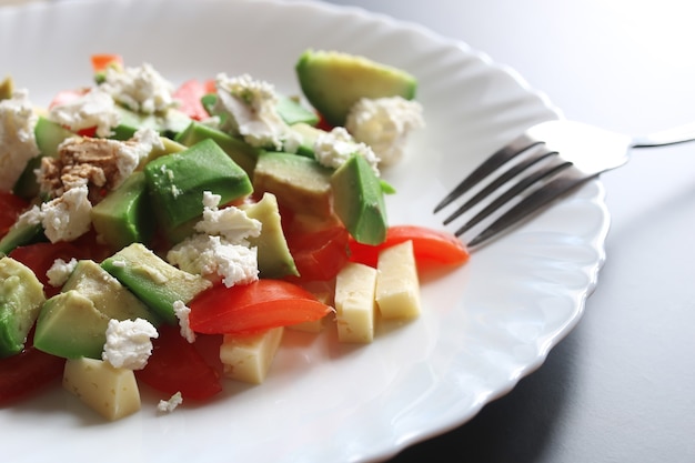 Fresh avocado delicious Mediterranean salad with cherry tomatoes and almonds and feta cheese Parmesan