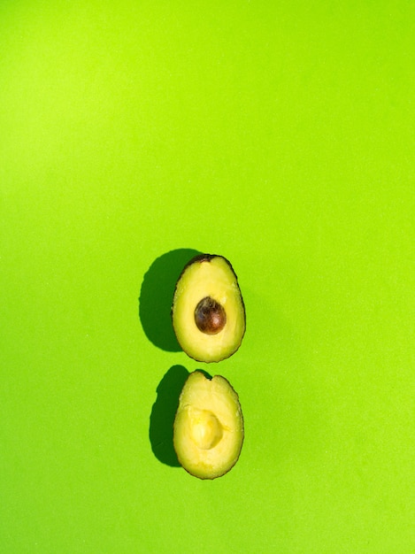 Fresh avocado on a green background