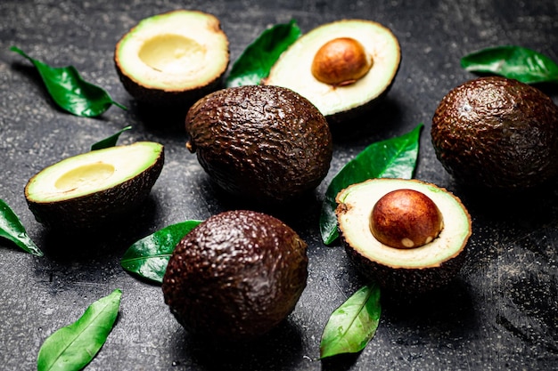 Fresh avocado with leaves On a black background