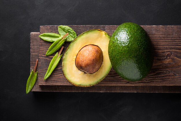 Fresh avocado on wooden board