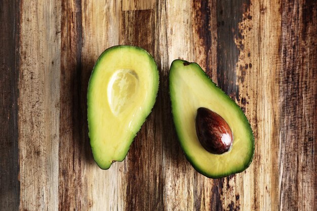 Fresh avocado on wooden table top view