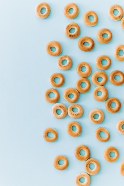 Fresh bagel on blue background