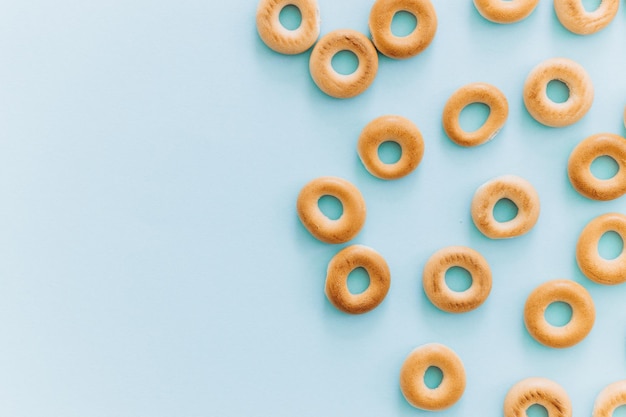 Fresh bagel on blue background