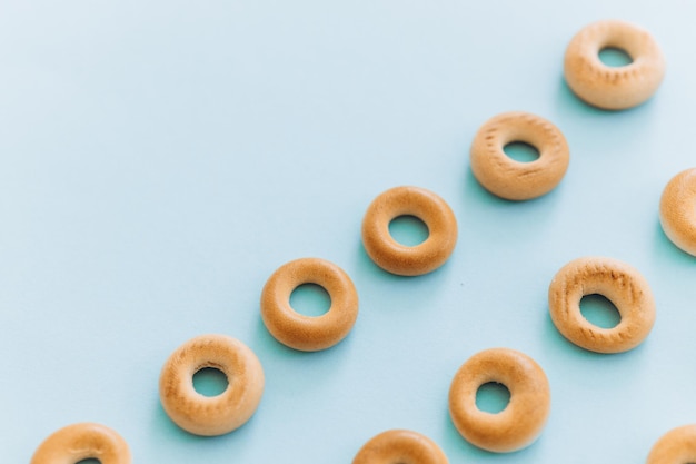 Fresh bagel on blue background