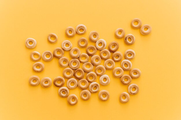 Fresh bagel on yellow background