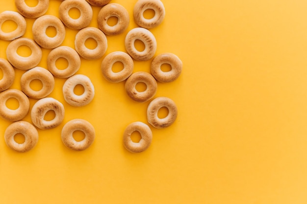 Fresh bagel on yellow background