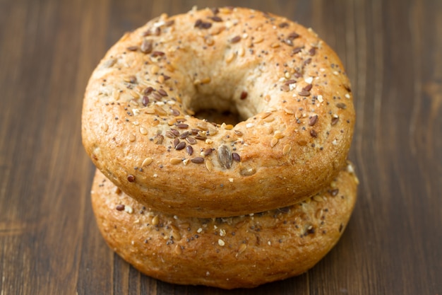 Fresh bagels on brown wooden background