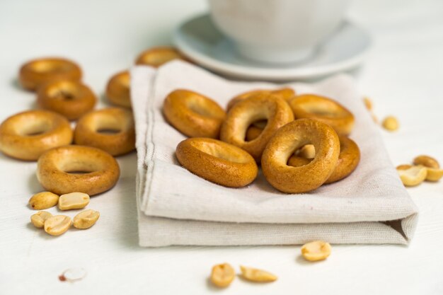 Fresh bagels and peanuts on a cloth napkin