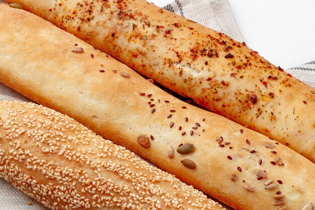 Fresh baguette bread on white wooden table