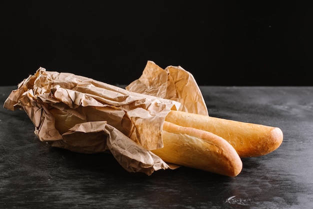 Fresh baked baguetes on the wooden background