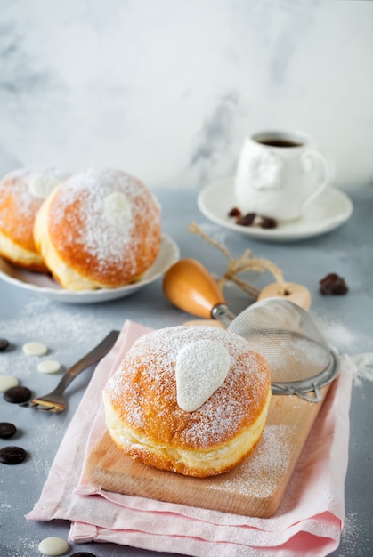 Fresh baked berliner with custard on a gray concrete 