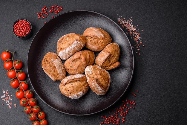 Fresh baked bread buns with salt spices seeds and grains