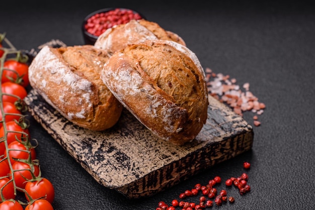 Fresh baked bread buns with salt spices seeds and grains