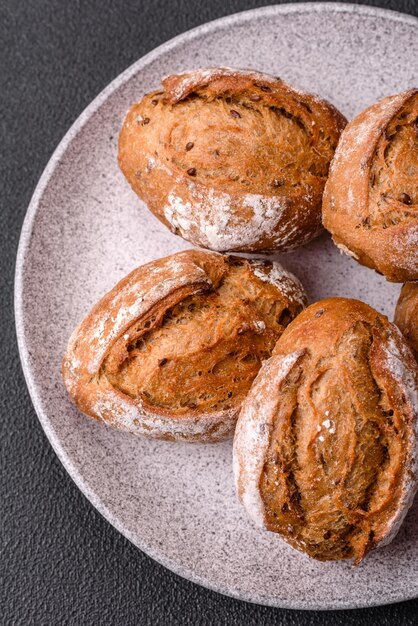 Fresh baked bread buns with salt spices seeds and grains