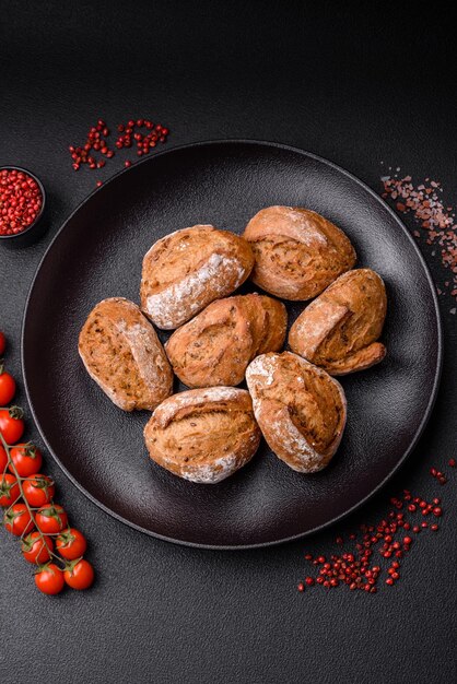 Fresh baked bread buns with salt spices seeds and grains