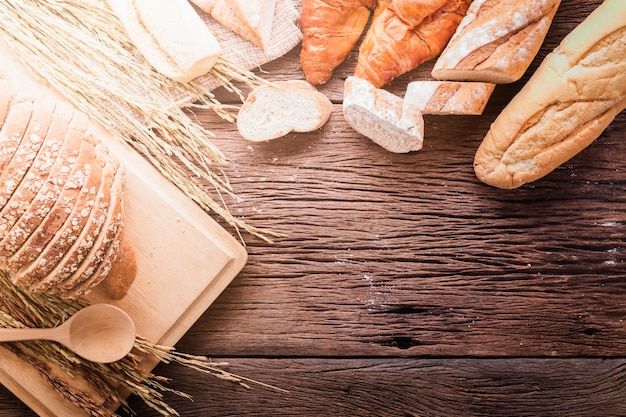 Fresh baked bread on dark wood table