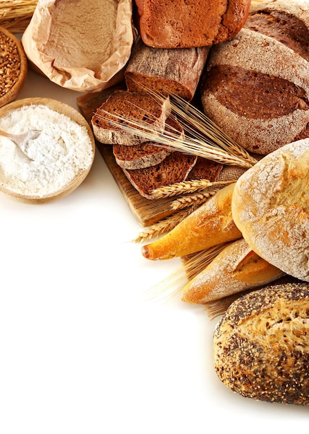 Fresh baked bread flour and wheat ears isolated on white