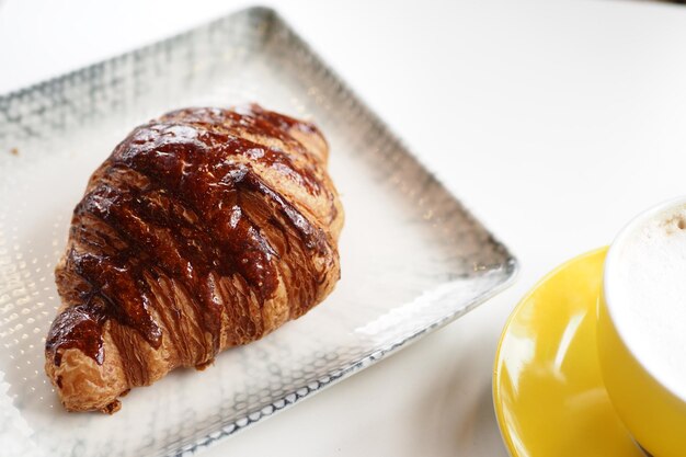 Fresh baked croissant on plate with copy space