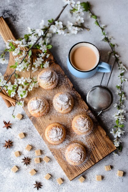 Fresh baked cupcakes of rice flour with banana and vanilla with a mug of hot chocolate. Delicious invigorating breakfast with hot chocolate and cupcakes