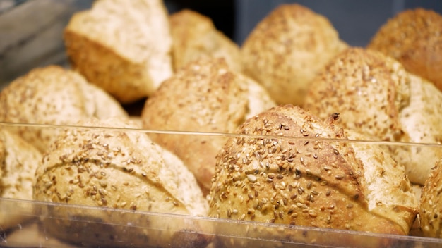 Fresh Baked Healthy Whole Bread Rolls Pastry with Sesame and Linseed Shopping at the grocery store Selling food concept