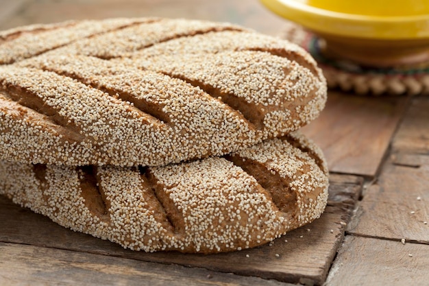 Photo fresh baked moroccan semolina bread on a wooden table close up