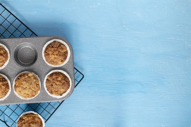 Fresh baked muffins on bright blue 