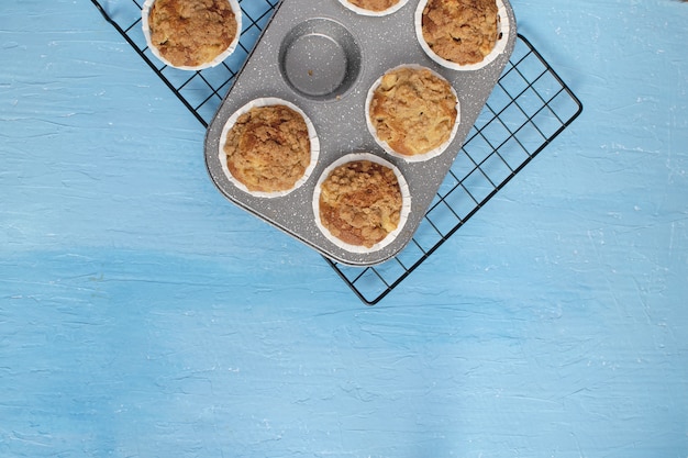 Fresh baked muffins on bright blue 