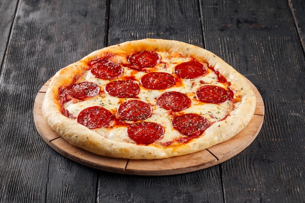 Fresh baked pepperoni, pizza on wooden surface