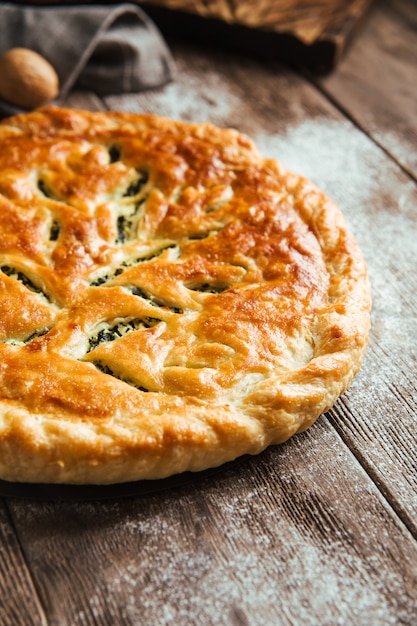 Fresh baked pie with spinach and cheese filling