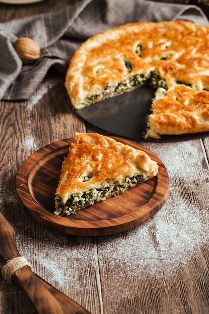 Fresh baked pie with spinach and cheese filling