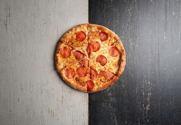 Photo fresh baked pizza with ingredients on a dark stone table