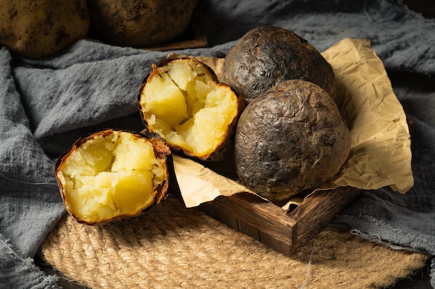Fresh baked potatoes on a dark background