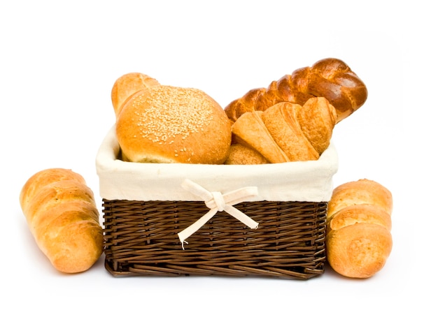 Fresh baked rolls in a basket on white