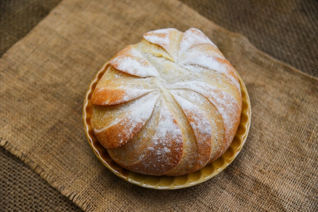 Fresh Bakery bread tray on the sack background homemade breakfast food concept Round loaf of bread