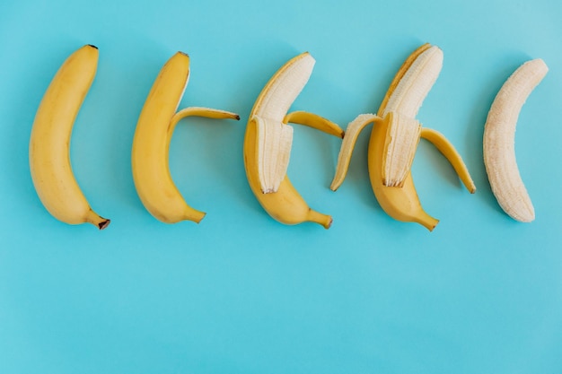 Fresh bananas on a blue background Flat lay Fruit backgroundColorful fruit pattern Space for text