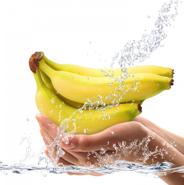 Fresh bananas falling in water