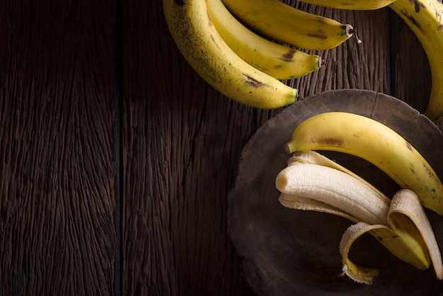 Fresh bananas on wooden background