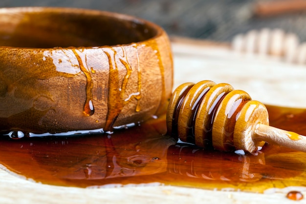 Fresh bee honey poured on a board