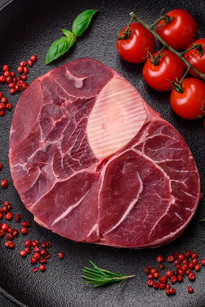 Fresh beef ossobuco steak with salt spices and herbs