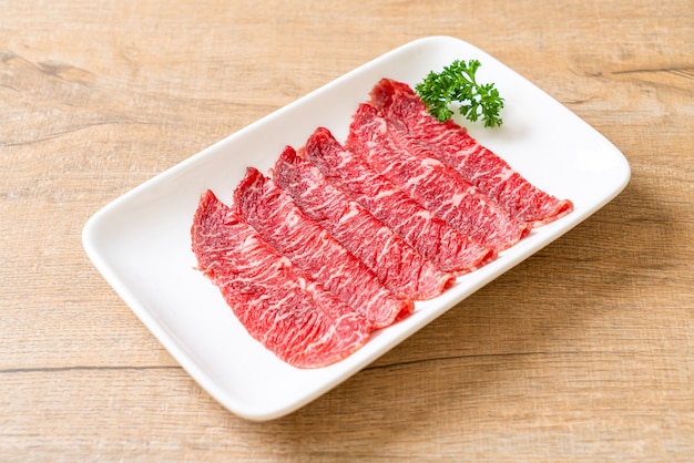 fresh beef raw sliced with marbled texture served for Sukiyaki and Shabu or Yakiniku