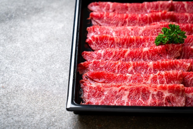 fresh beef raw sliced with marbled texture served for Sukiyaki and Shabu or Yakiniku