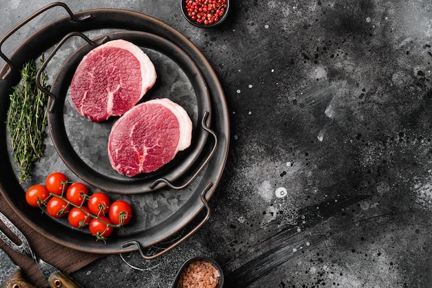 Fresh beef steak sliced set on black dark stone table background top view flat lay with copy space for text