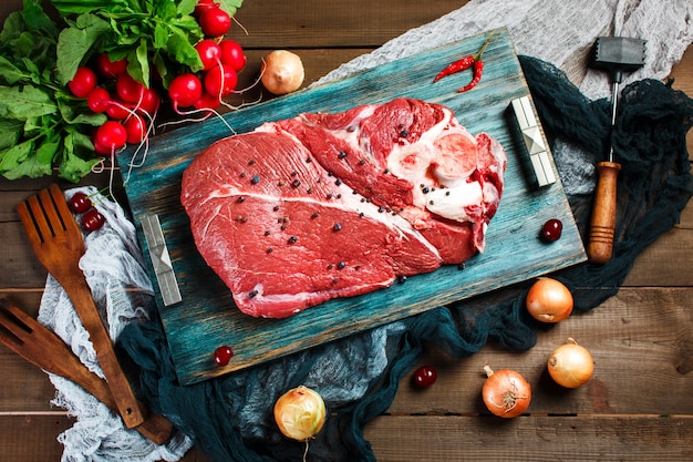 Fresh beef veal meat on rustic wooden table