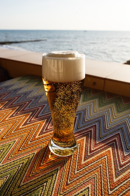 Fresh beer in a cafe by the sea on a sunny day