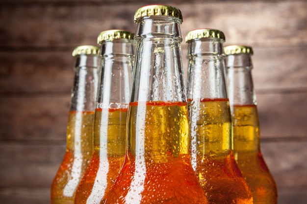 Fresh beer in glass bottles on wooden 