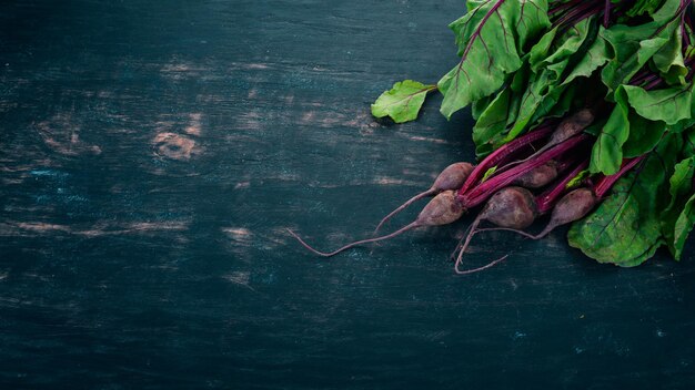 Fresh beetroot with green leaves On a wooden background Top view Copy space