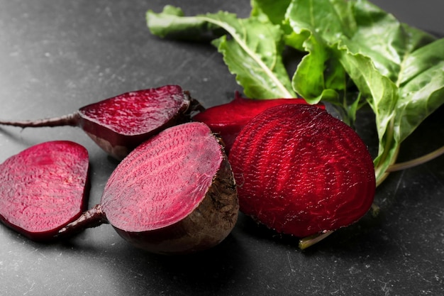 Fresh beetroots with tops on grey background