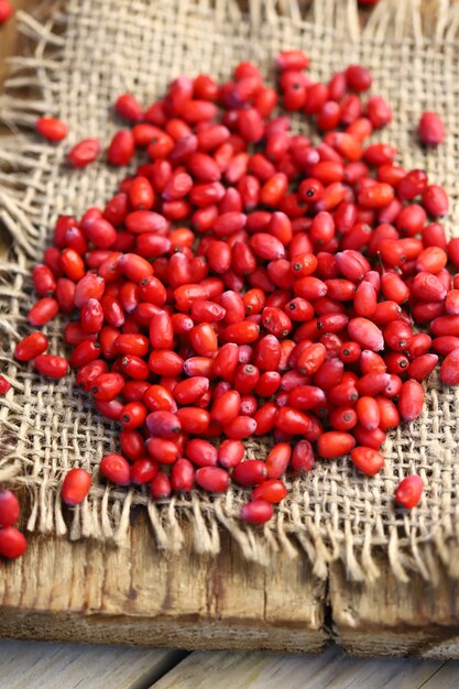 Fresh berries of barberry on a wooden surface.