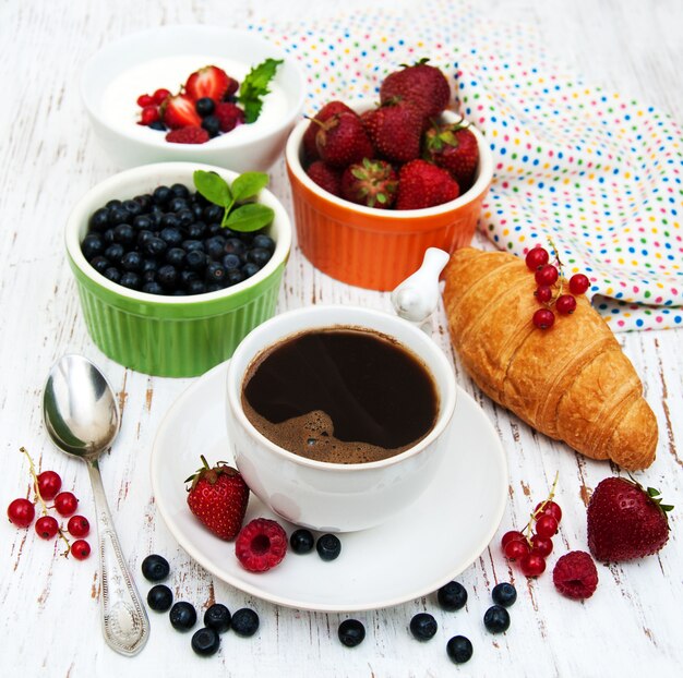 Fresh berries, coffee and croissant