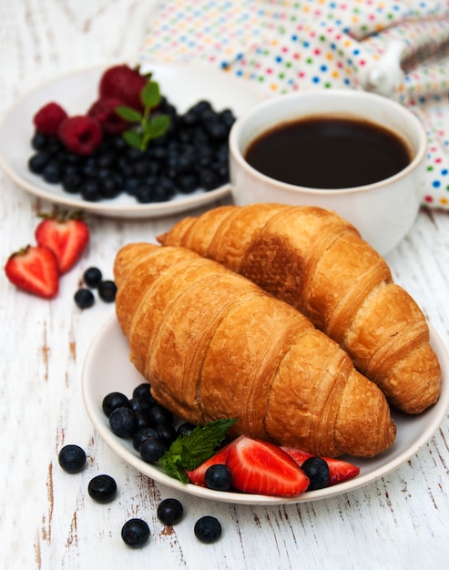 Fresh berries, coffee and croissant